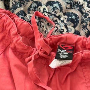 Coral scrub pants with elastic/drawstring waist and cargo pockets on both legs